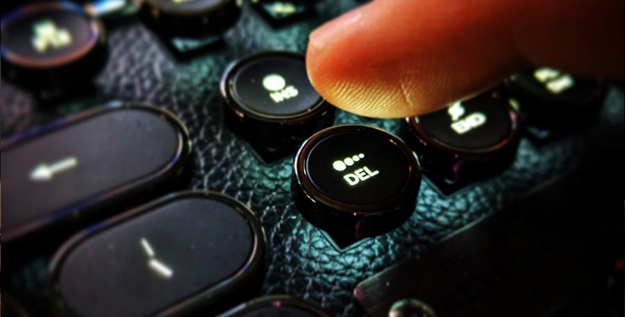 Hands hover over a keyboard while editing